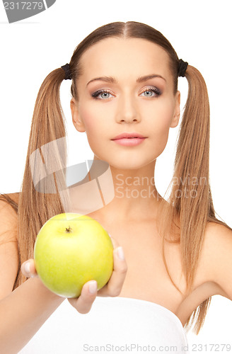 Image of young beautiful woman with green apple