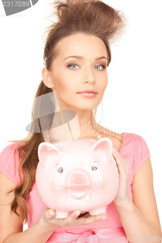 Image of lovely woman with piggy bank