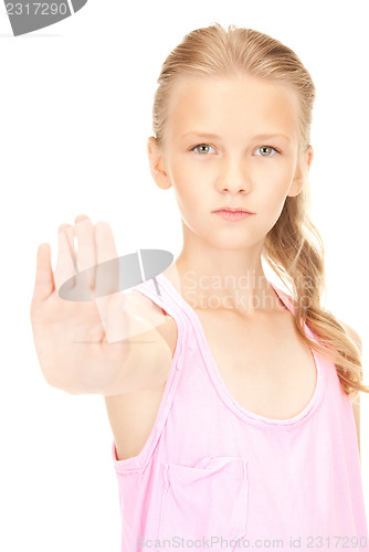 Image of lovely girl showing stop sign