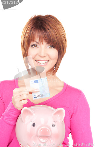 Image of lovely woman with piggy bank and money