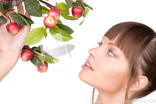 Image of lovely woman with apple twig