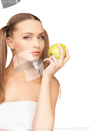 Image of young beautiful woman with green apple