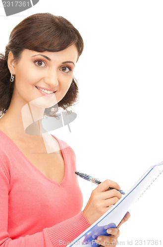 Image of young attractive businesswoman with notebook