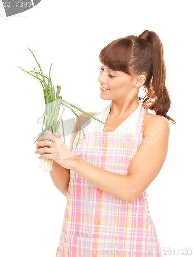 Image of beautiful housewife with spring onions over white