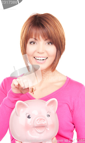 Image of lovely woman with piggy bank and money