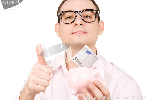 Image of businessman with piggy bank and money