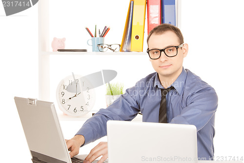 Image of businessman with laptop computer in office