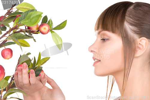 Image of lovely woman with apple twig