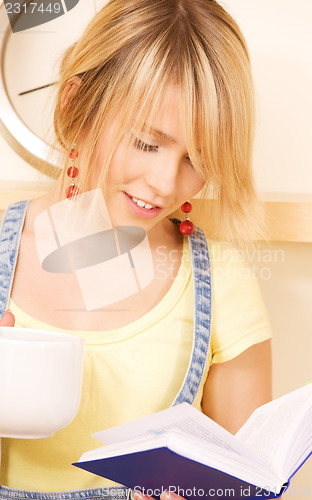 Image of teenage girl with book and mug