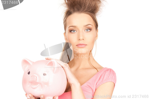 Image of lovely woman with piggy bank