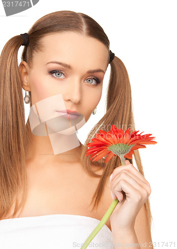 Image of woman in towel with red flower