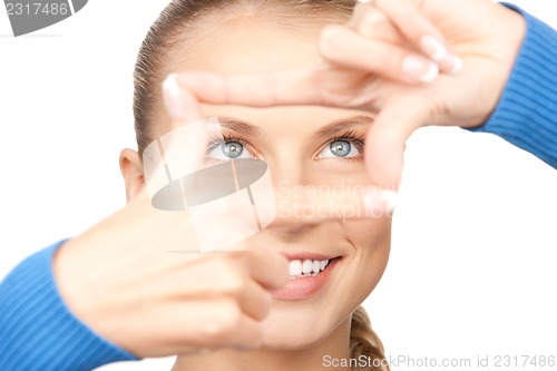 Image of lovely woman creating a frame with fingers