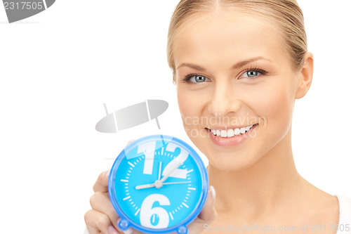 Image of woman holding alarm clock