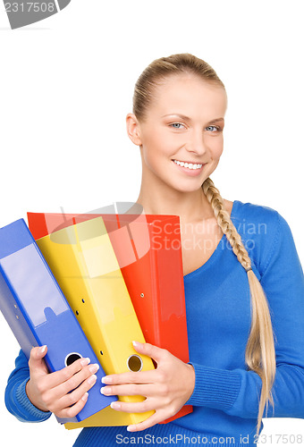 Image of young attractive businesswoman with folders