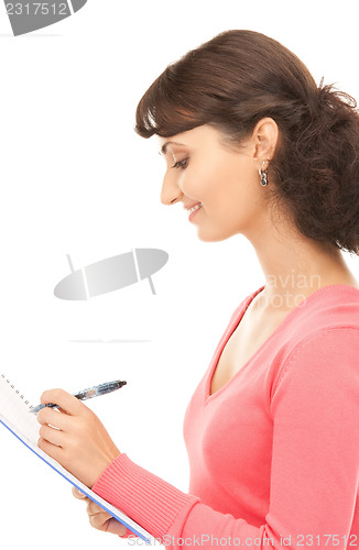 Image of young attractive businesswoman with notebook