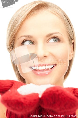 Image of beautiful woman in red mittens with snow