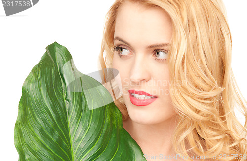 Image of woman with green leaf over white