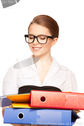 Image of young attractive businesswoman with folders