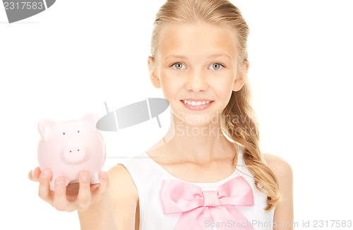 Image of lovely teenage girl with piggy bank