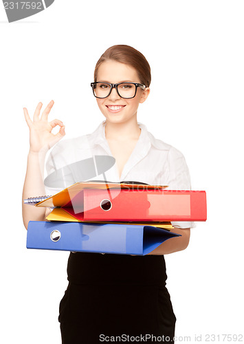 Image of young attractive businesswoman with folders