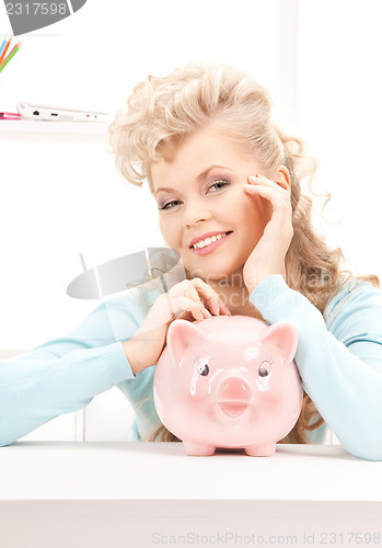 Image of lovely woman with piggy bank