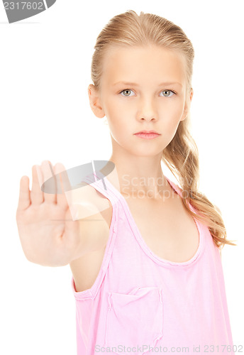 Image of lovely girl showing stop sign