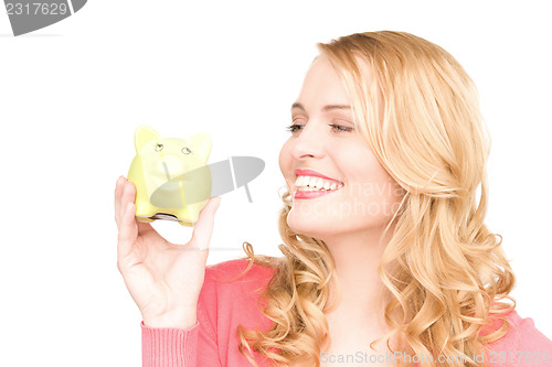 Image of lovely woman with piggy bank