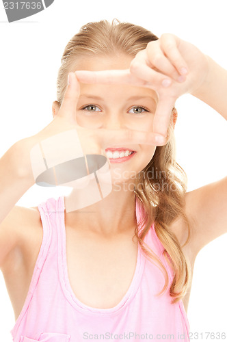 Image of pretty girl creating a frame with fingers