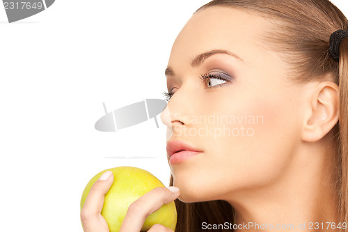 Image of young beautiful woman with green apple