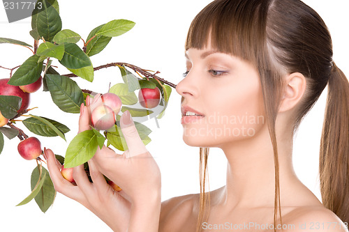 Image of lovely woman with apple twig