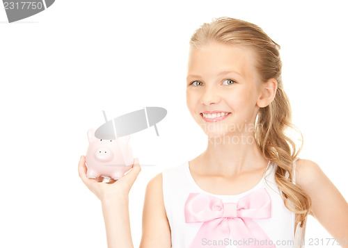 Image of lovely teenage girl with piggy bank