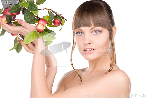 Image of lovely woman with apple twig