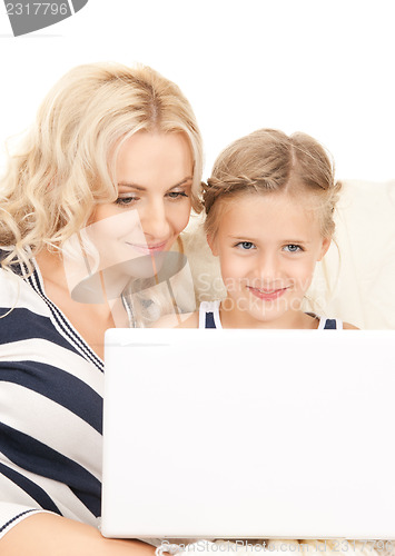 Image of happy mother and child with laptop computer