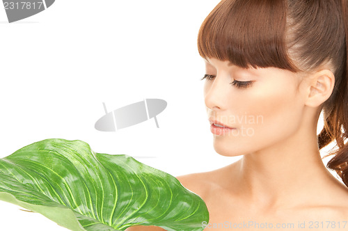 Image of woman with green leaf