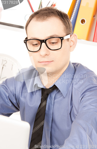 Image of businessman with laptop computer in office