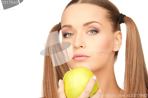 Image of young beautiful woman with green apple