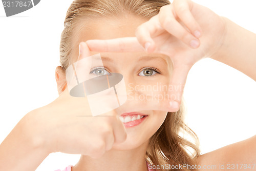 Image of pretty girl creating a frame with fingers