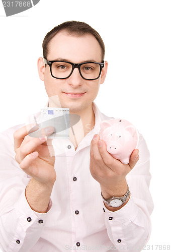 Image of businessman with piggy bank and money