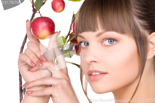 Image of lovely woman with apple twig