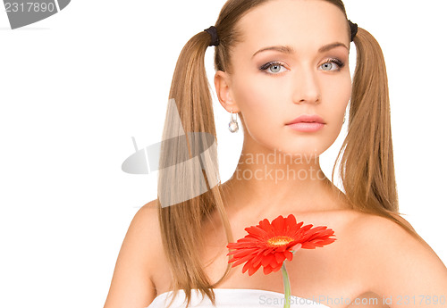 Image of woman in towel with red flower