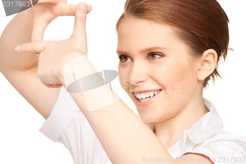 Image of lovely woman creating a frame with fingers