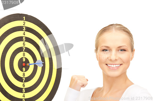 Image of businesswoman with dart and target