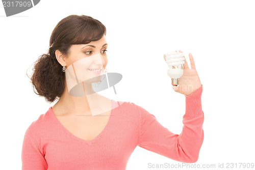 Image of woman holding energy saving bulb