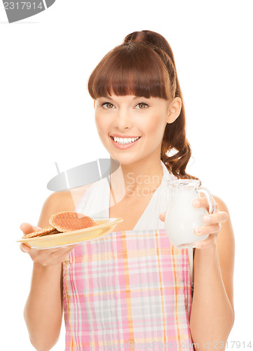 Image of housewife with milk and cookies