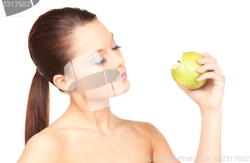 Image of young beautiful woman with green apple