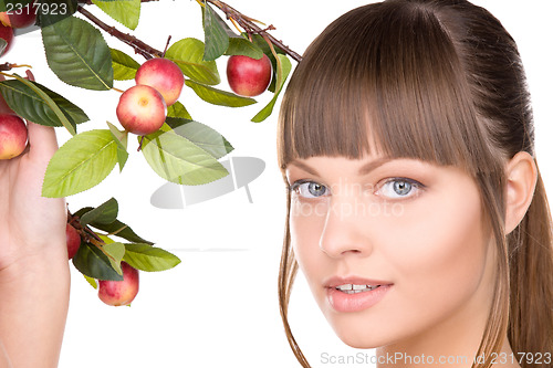 Image of lovely woman with apple twig
