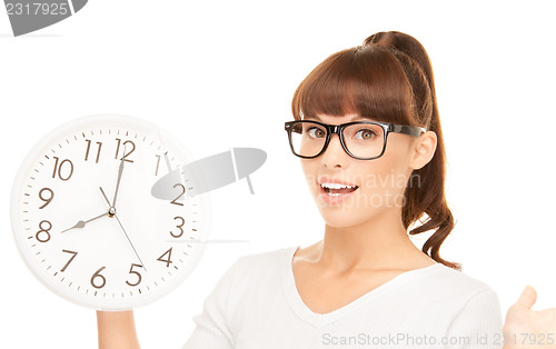 Image of woman holding big clock
