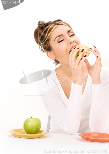 Image of woman with green apple and sandwich