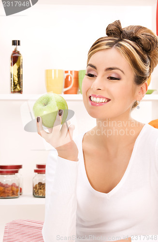 Image of young beautiful woman with green apple