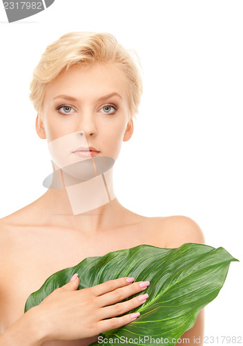 Image of woman with green leaf